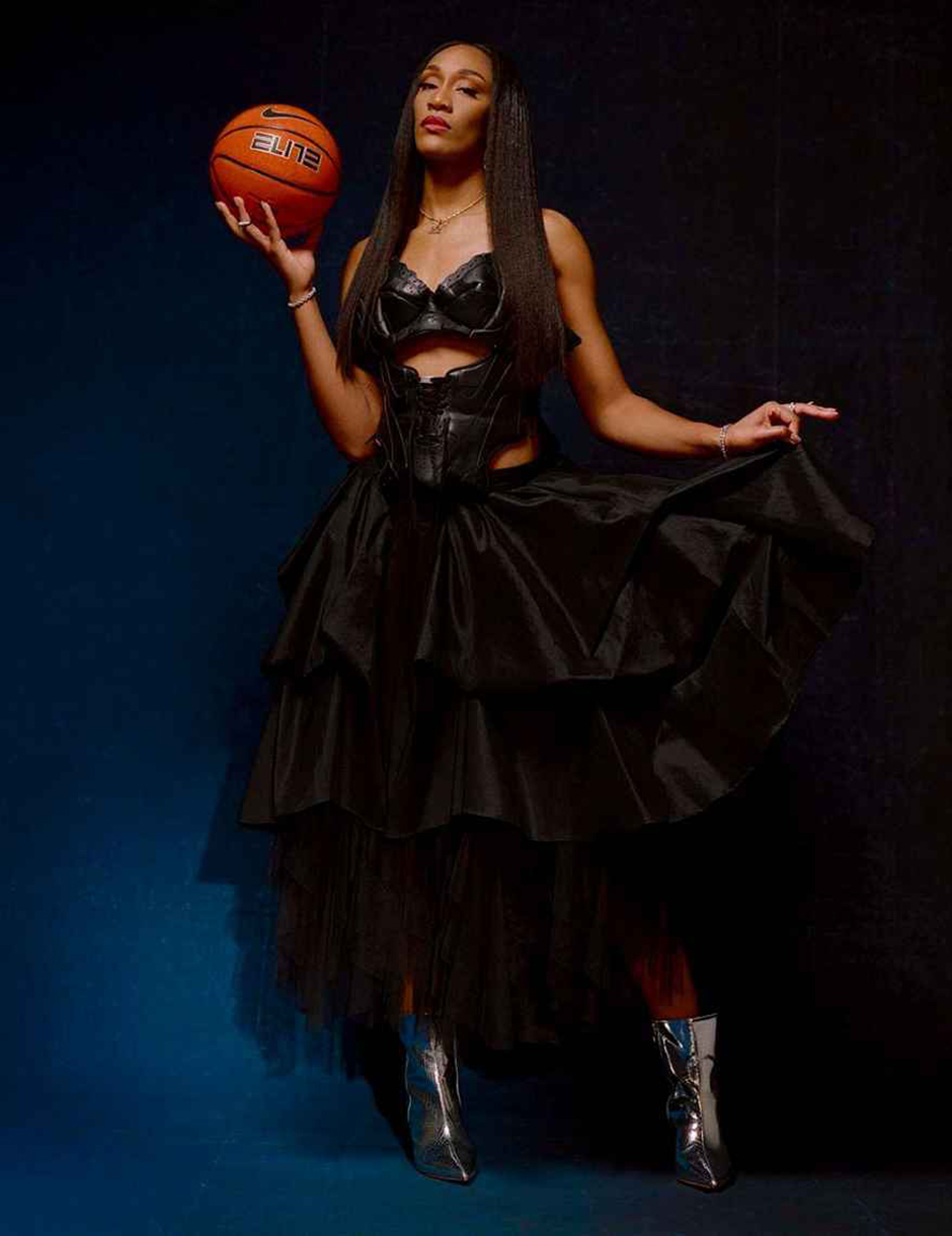 AJ'a Wilson holding a basketball wearing GB Jewelry