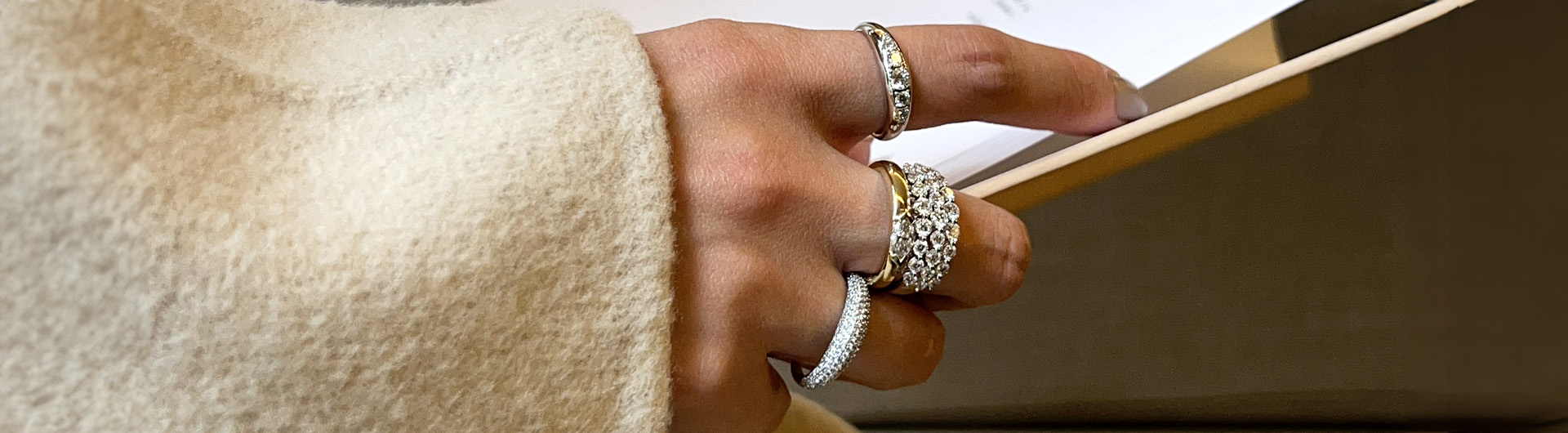 Hand wearing gold lab grown diamond jewellery Hand wearing gold lab grown diamond jewellery