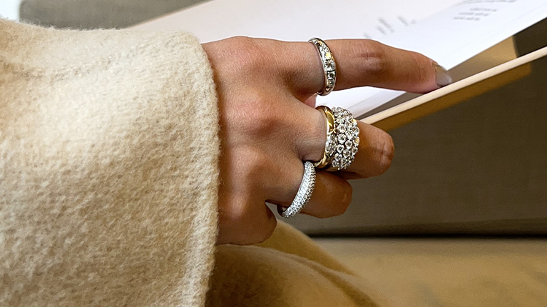 Hand wearing gold lab grown diamond jewellery Hand wearing gold lab grown diamond jewellery