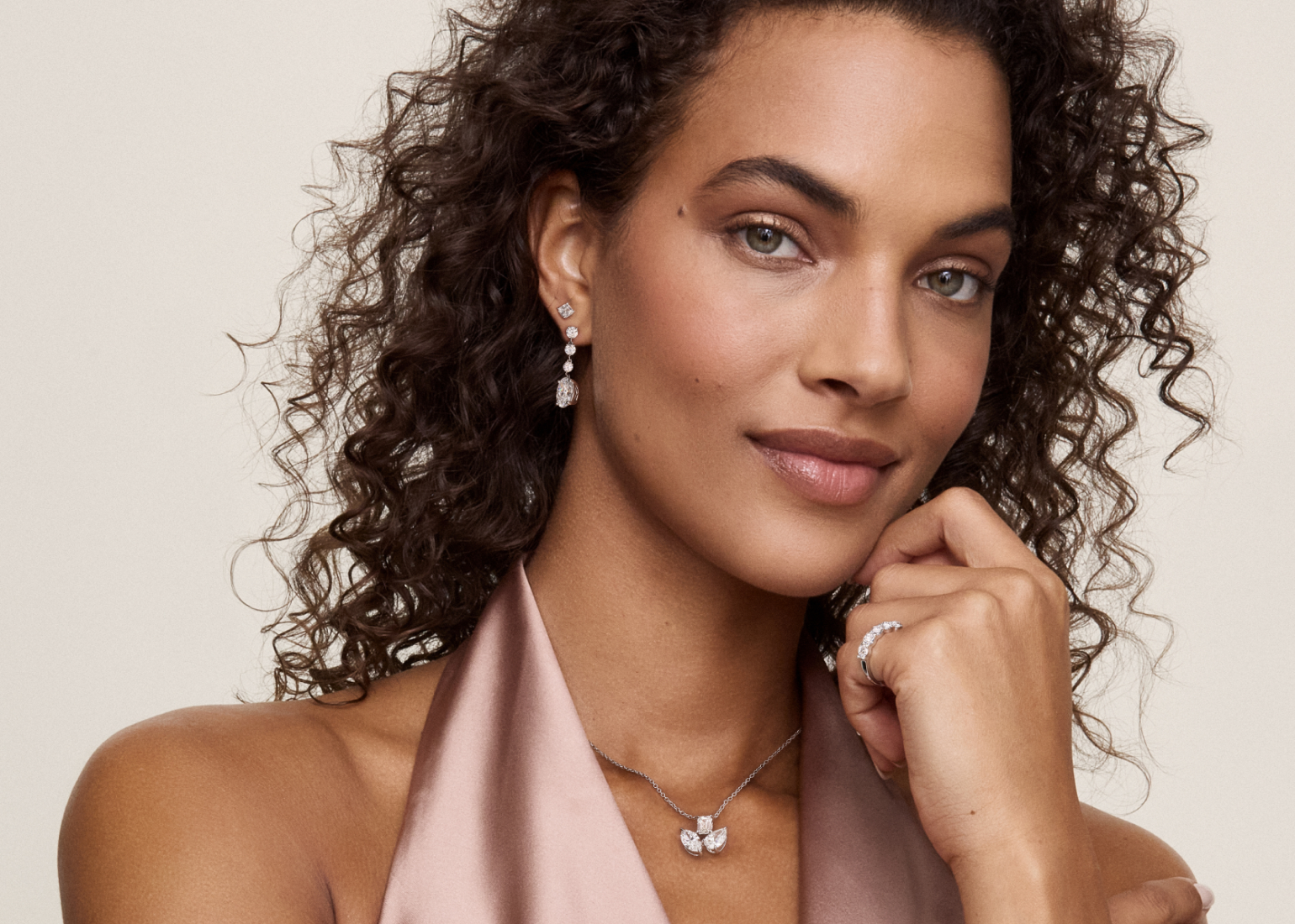 Smiling female model fashion diamond necklaces, earrings, rings, and bracelets