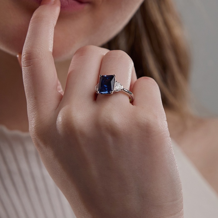 10x8mm Radiant Cut Created Sapphire and 5/8 ctw Lab Grown Diamond Three-Stone Engagement Ring